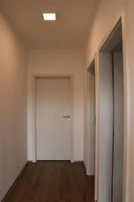 an empty hallway with a white door and wooden floors at Vyhlídka Slapy Nová Živohošť in Křečovice