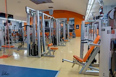 a gym with a row of exercise equipment at AXA Hotel in Prague