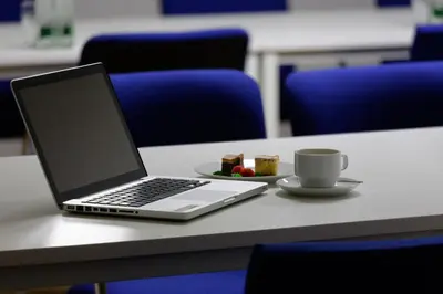 a laptop computer sitting on a table with a cup of coffee at AXA Hotel in Prague