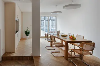 a kitchen and dining room with a table and chairs at AXA Hotel in Prague