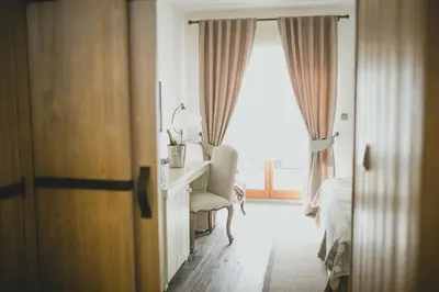a bedroom with a desk and a bed and a window at Resort Čapí Hnízdo in Olbramovice Ves