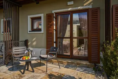 a patio with a table and chairs on a balcony at Resort Čapí Hnízdo in Olbramovice Ves