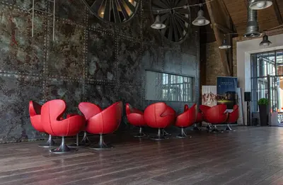 a row of red chairs in a room at Resort Čapí Hnízdo in Olbramovice Ves