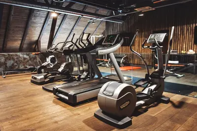 a gym with several treadms and cardio machines at Resort Čapí Hnízdo in Olbramovice Ves