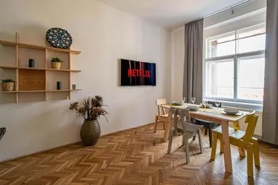 a dining room with a table and chairs and a window at Super Central Billiard and Darts Big Apartment in Prague