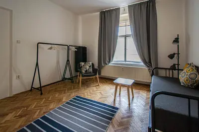a living room with a couch and a window at Super Central Billiard and Darts Big Apartment in Prague