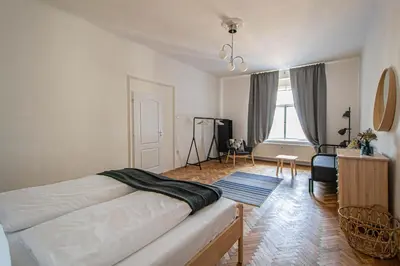 a bedroom with a bed and a living room at Super Central Billiard and Darts Big Apartment in Prague