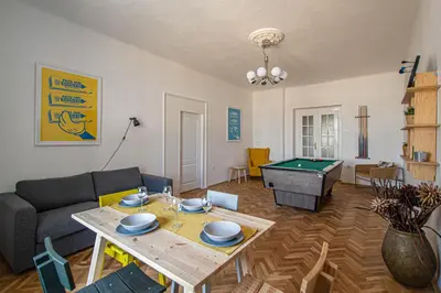 a living room with a ping pong table and a couch at Super Central Billiard and Darts Big Apartment in Prague
