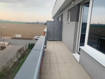 a balcony of a building with a view of a field at Apartment IRON CUBE in Prague