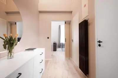 a bathroom with a tub and a sink and a tub and a mirror at OREA Place Seno in Prague