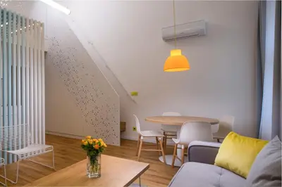 a bedroom with a white bed with a skylight at OREA Place Seno in Prague