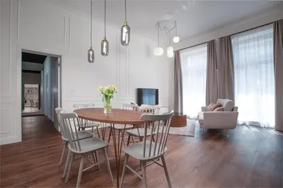 a room with tables and chairs and a mirror at OREA Place Seno in Prague