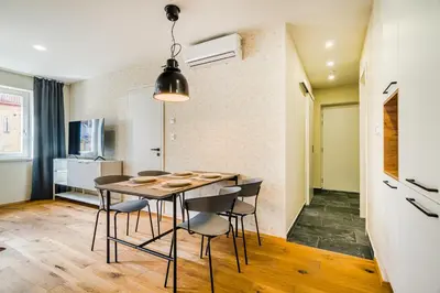 a room with a mirror and a balcony at Prague Days - Premium Loft with AC & View of the Žižkov Tower from Spacious Terrace in Prague