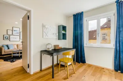 a kitchen with white cabinets and a sink at Prague Days - Premium Loft with AC & View of the Žižkov Tower from Spacious Terrace in Prague