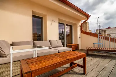 a kitchen and dining room with a table and chairs at Prague Days - Premium Loft with AC & View of the Žižkov Tower from Spacious Terrace in Prague