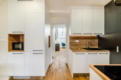 a living room with a couch and a table at Prague Days - Premium Loft with AC & View of the Žižkov Tower from Spacious Terrace in Prague