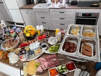 a kitchen counter with many different types of food on it at Ubytování U Synagogy Dobříš in Dobříš