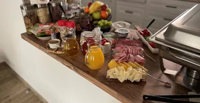 a buffet of food on a counter in a kitchen at Ubytování U Synagogy Dobříš in Dobříš