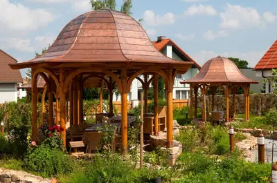 a wooden gazebo in the middle of a garden at Babiččina Zahrada Penzion & Restaurant in Pruhonice