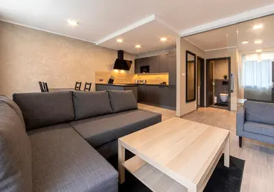 a living room with a couch and a table at Gesto Apartments in Prague
