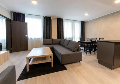 a living room with a couch and a table at Gesto Apartments in Prague