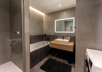 a bathroom with a sink and a tub and a mirror at Gesto Apartments in Prague
