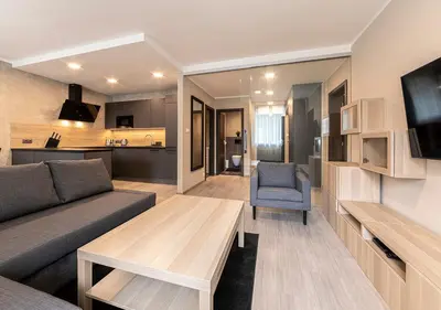 a living room with a couch and a table and a tv at Gesto Apartments in Prague