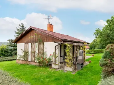 a small white cottage with a grass yard at Holiday Home Měřín by Interhome in Rabyně