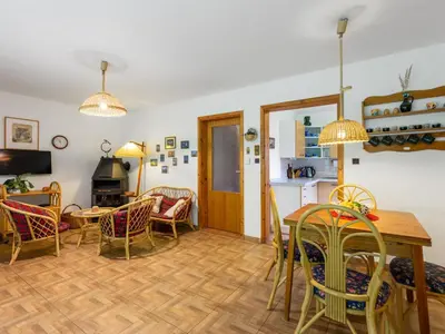 a kitchen and dining room with a table and chairs at Holiday Home Měřín by Interhome in Rabyně