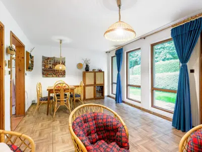 a living room with a table and chairs at Holiday Home Měřín by Interhome in Rabyně