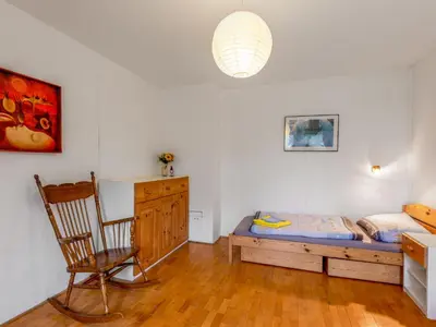 a bedroom with a bed and a chair and a desk at Holiday Home Měřín by Interhome in Rabyně