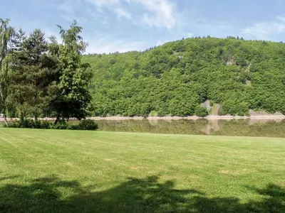 a field of green grass with a hill in the background at Holiday Home Měřín by Interhome in Rabyně
