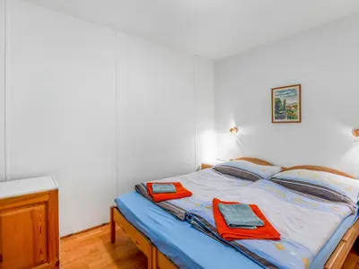a bedroom with a bed with two towels on it at Holiday Home Měřín by Interhome in Rabyně