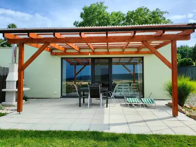 a pergola on a patio with a table and chairs at Panorama house Brdy in Příbram