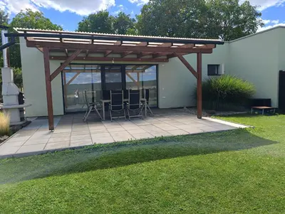 a pergola with chairs and a table on a patio at Panorama house Brdy in Příbram