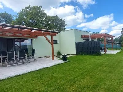 a patio with chairs and a pavilion in a yard at Panorama house Brdy in Příbram