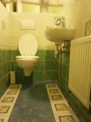 a bathroom with a toilet and a sink at Andrews Centre Apartment in Prague