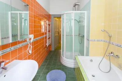 a bathroom with a tub and a sink and a shower at Andrews Centre Apartment in Prague