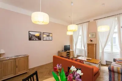 a living room with a couch and a table at Andrews Centre Apartment in Prague