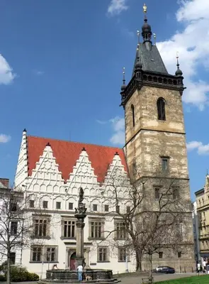 a building with a clock tower in front of it at Andrews Centre Apartment in Prague
