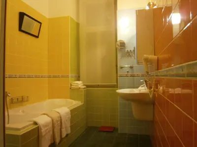 a bathroom with a tub and a sink at Andrews Centre Apartment in Prague