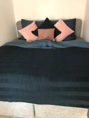 a bed with four pillows on top of it at Apartman Romantica in Poděbrady