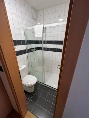 a bathroom with a toilet and a shower at Blue Orange Resort in Prague