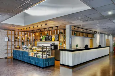 a restaurant with a counter in the middle of a room at Blue Orange Resort in Prague
