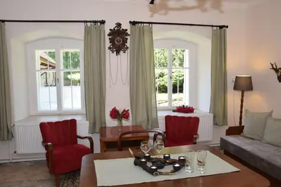 a living room with a couch and a table at Hájovna hradu Houska in Doksy