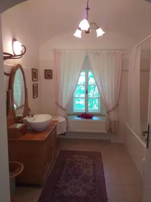a bathroom with a sink and a window at Hájovna hradu Houska in Doksy