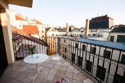 a balcony with a table and a view of a city at Luxury Loft in Prague