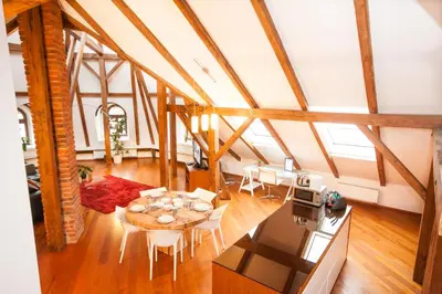 a kitchen and a living room with a table and chairs at Luxury Loft in Prague