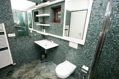 a bathroom with a toilet and a sink and a mirror at Luxury Loft in Prague
