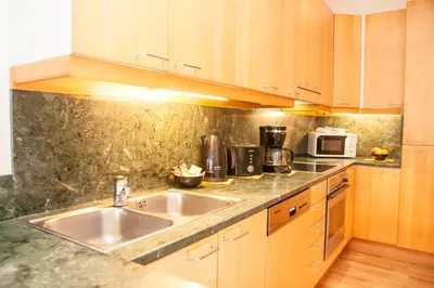 a kitchen with a sink and a microwave at Wenceslas Square Lofts in Prague